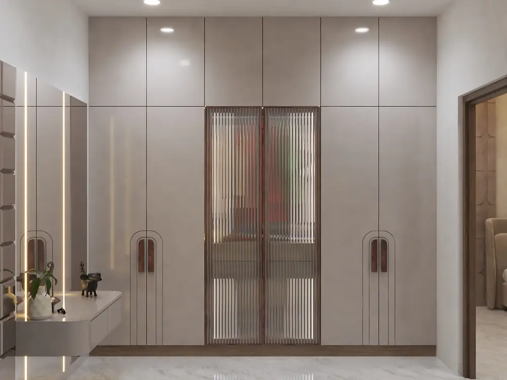 A taupe dressing room with fluted glass doors and warm interior lighting.