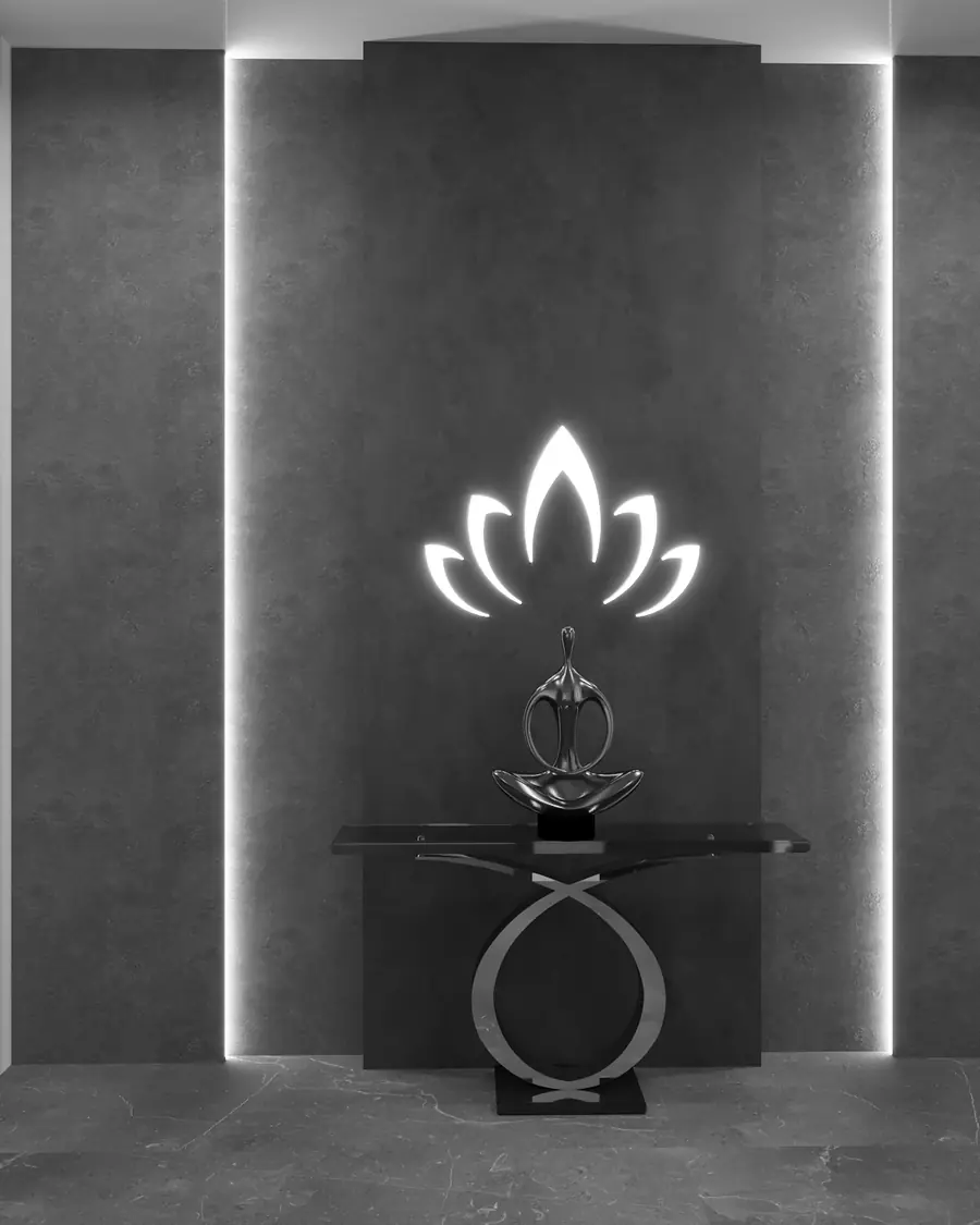 A dark stone entrance wall with a backlit sculptural motif above a slim console.
